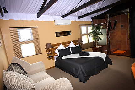 Another of our air-conditioned rooms showing part of the en-suite bathroom