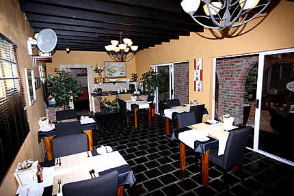 The spacious dining room with atrium seating area through the arch